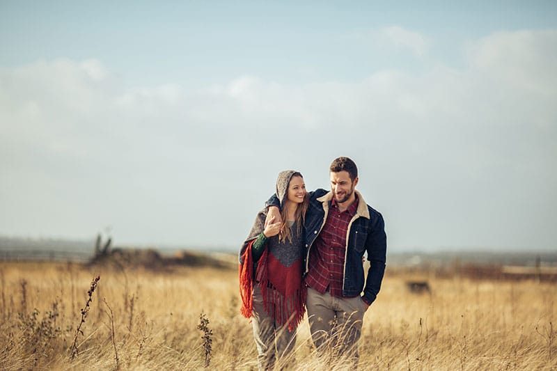 Couple Walking In A Field